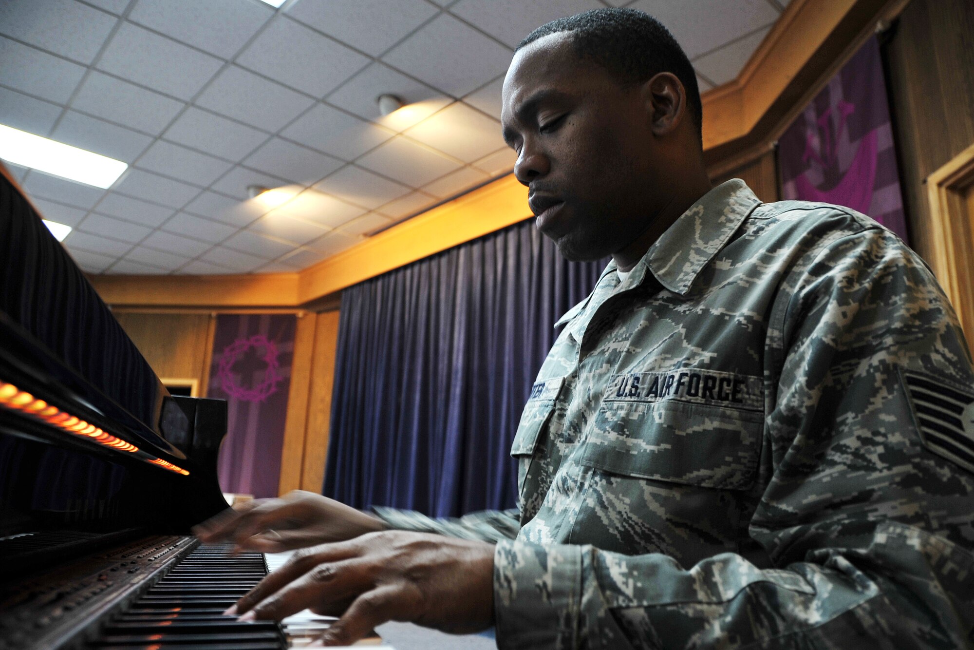 Tech. Sgt. Robert Carter, 7th Air Force knowledge operations NCO in charge, practices a song on the piano at the base chapel March 13, 2013. Since being stationed at Osan, Carter has worked with the chapel gospel choir, sung national anthems, written and produced his own music and has joined a local band called Those Guys. (U.S. Air Force photo/Senior Airman Kristina Overton)