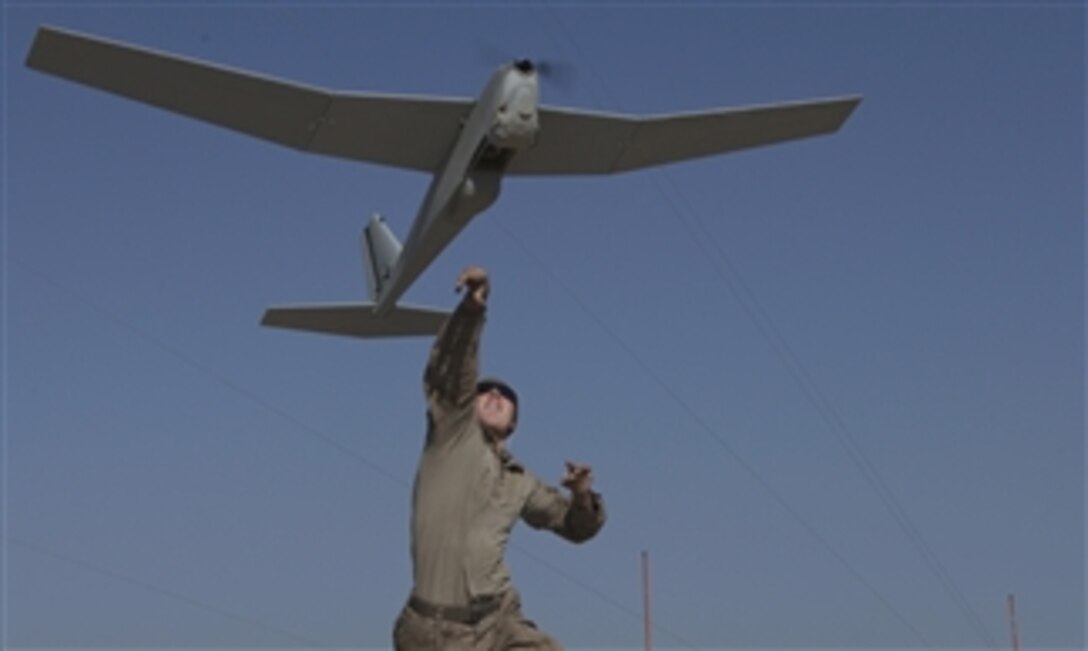 U.S. Marine Corps Lance Cpl. Nathan Bush launches an RQ-20A Puma unmanned aerial vehicle during an operation at Patrol Base Boldak in Afghanistan on March 4, 2013.  Bush is a member of Weapons Company, 2nd Battalion, 7th Marine Regiment.  