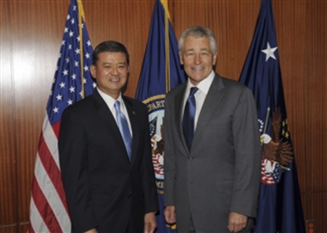 Secretary of Veterans Affairs Eric K. Shinseki, left, and Secretary of Defense Chuck Hagel pose for photographers during a meeting at the U.S. Department of Veterans Affairs in Washington, D.C., on March 12 2013