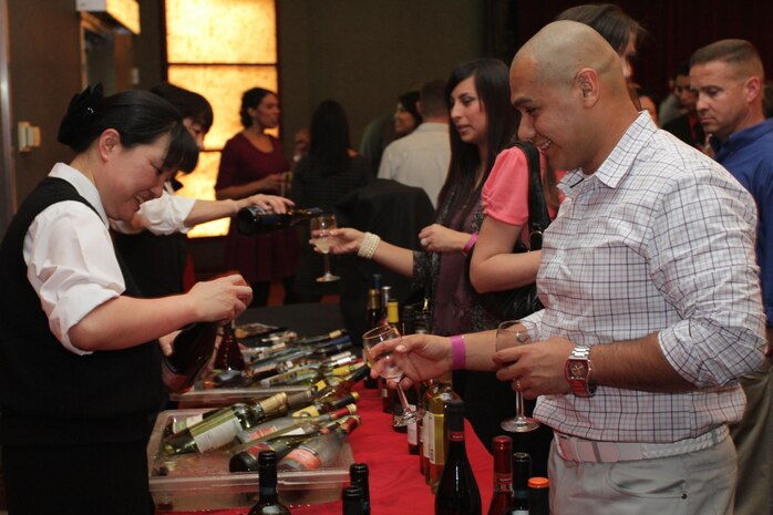 Mike Rodriguez, Marine Corps Community Services 12th Annual Wine Festival attendee, prepares to receive a sample of red wine for himself and his wife during the festival in the Club Iwakuni Ballroom March 9, 2013. MCCS sells 500 tickets for the festival, usually selling out two to three weeks after they go on sale.