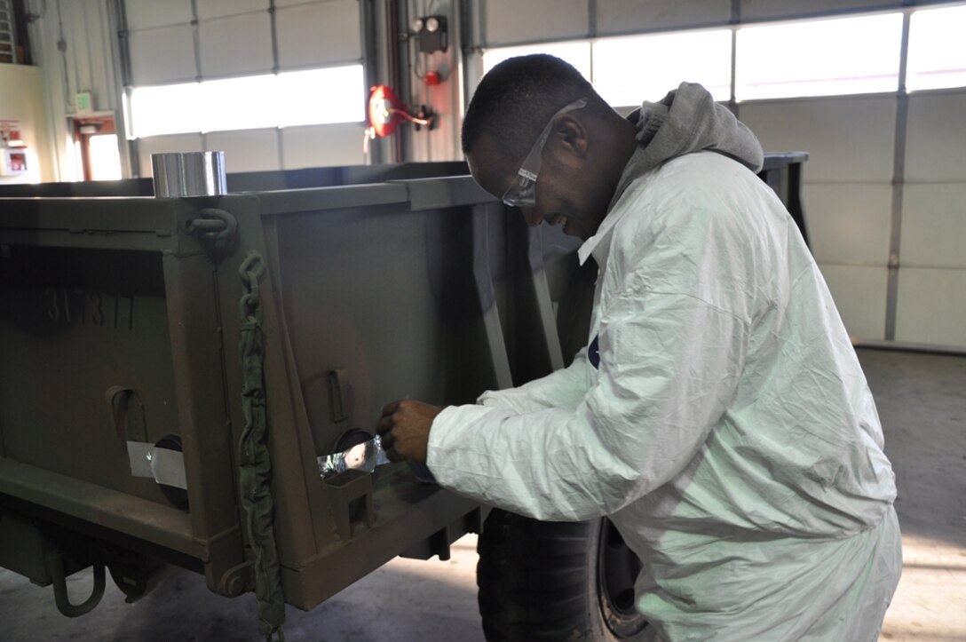 Deshawn Phillips, a preservation mechanic on Strip 8 with Fleet Support Division on Marine Corps Logistics Base Barstow, Yermo Annex, Calif., preserves a M101 trailer, March 8.
