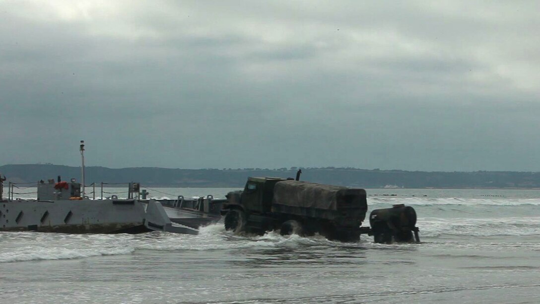 Marines with 1st Marine Logistics Group load a 7-ton vehicle onto an improved Navy lighterage system to ferry it to the USNS Bob Hope, Tuesday, March 5, 2013. The Bob Hope was on-loaded and off-loaded with military vehicles during exercise Brilliant Scepter.
A Humvee sits as it awaits to be loaded onto an improved Navy lighterage system to ferry it to the USNS Bob Hope, Tuesday, March 5, 2013. The Bob Hope was on-loaded and off-loaded with military vehicles during exercise Brilliant Scepter.
