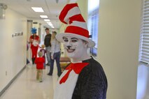 The Cat in the Hat. Thing 1, Thing 2 and Marine Corps Air Station New River Library employees greeted service member and their family to the Read Across America event held at the library, Mar. 1.  Members of Marine Corps Community Services and Coastal Carolina Community College read excerpts of Dr. Seuss books to more than 130 people who all read along as the book as displayed on a projector screen. Read Across America is held every year on the school date closest to Dr. Seuss’ birthday, Mar. 2, to promote reading in children of all ages.
