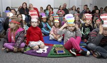 The Cat in the Hat. Thing 1, Thing 2 and Marine Corps Air Station New River Library employees greeted service member and their family to the Read Across America event held at the library, Mar. 1.  Members of Marine Corps Community Services and Coastal Carolina Community College read excerpts of Dr. Seuss books to more than 130 people who all read along as the book as displayed on a projector screen. Read Across America is held every year on the school date closest to Dr. Seuss’ birthday, Mar. 2, to promote reading in children of all ages.