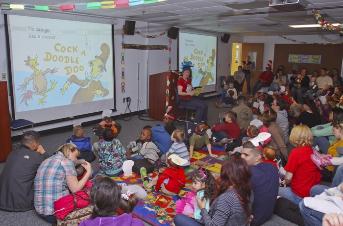 The Cat in the Hat. Thing 1, Thing 2 and Marine Corps Air Station New River Library employees greeted service member and their family to the Read Across America event held at the library, Mar. 1.  Members of Marine Corps Community Services and Coastal Carolina Community College read excerpts of Dr. Seuss books to more than 130 people who all read along as the book as displayed on a projector screen. Read Across America is held every year on the school date closest to Dr. Seuss’ birthday, Mar. 2, to promote reading in children of all ages.