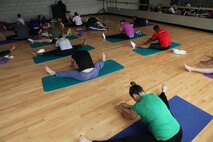 Attette Petrongelli, AS-4400 fitness and group fitness instructor leads her yoga class through one of her sessions, March 8. Yoga has many physical and mental health benefits to a wide range of individuals. 