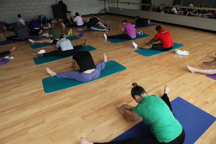 Attette Petrongelli, AS-4400 fitness and group fitness instructor leads her yoga class through one of her sessions, March 8. Yoga has many physical and mental health benefits to a wide range of individuals. 