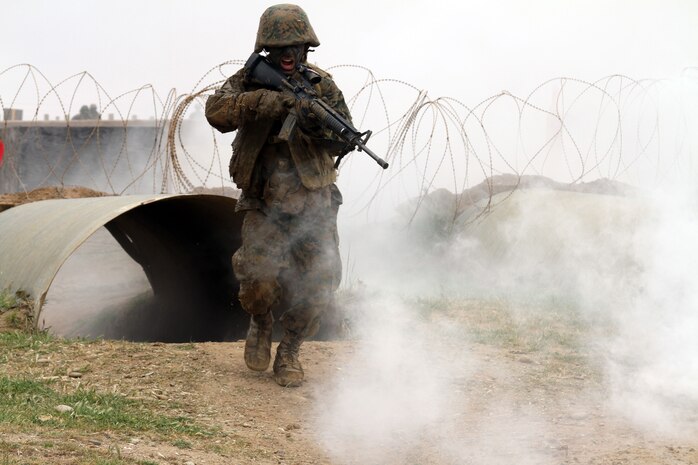 A recruit of Company C, 1st Recruit Training Battalion, rushes from one obstacle to the next during Copeland's Assault Course at Edson Range aboard Marine Corps Base Camp Pendleton, Calif. March 5. Recruits are put through a simulated, stressful combat environment so they can better their communication skills.
