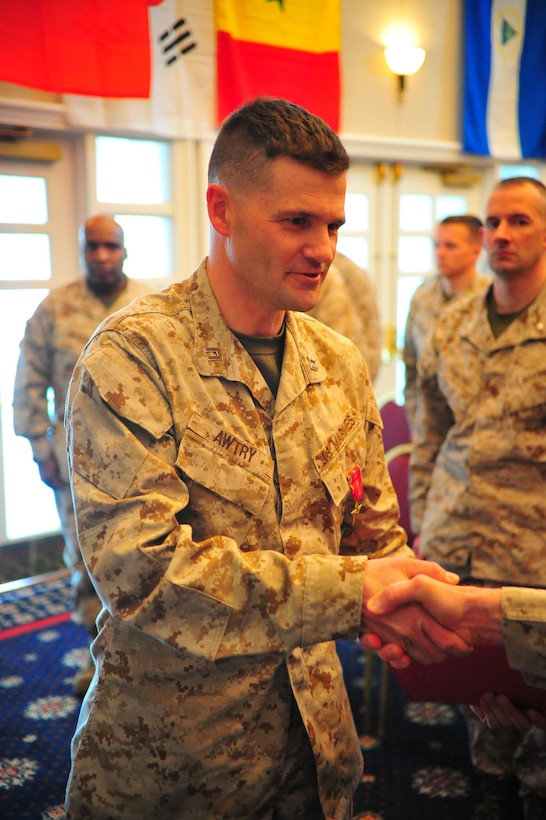 Capt. Aaron Awtry, ground company grade monitor for Manpower and Reserve Affairs, shakes hands after being awarded the bronze star with a combat distinguishing device on March 13 at The Clubs at Quantico. Awtry’s award is cited for events in support of Operation Enduring Freedom with Fox. Co, 2nd Battalion, 4th Marine Regiment.