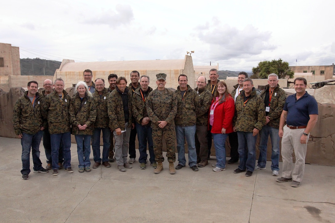 The participants of the West Coast Marine Corps Executive Forum pose with Brig. Gen. Vincent A. Coglianese at the Infantry Immersion Trainer on Marine Corps Base Camp Pendleton March 7. Coglianese is the base commanding general and regional authority for five military installations in the Southwestern United States. The Forum’s purpose is to educate and inform civilians of the Marine Corps’ operational capability, current programs and future initiatives in preparation for Marine Week, which will be held in Seattle, Wash. this year.