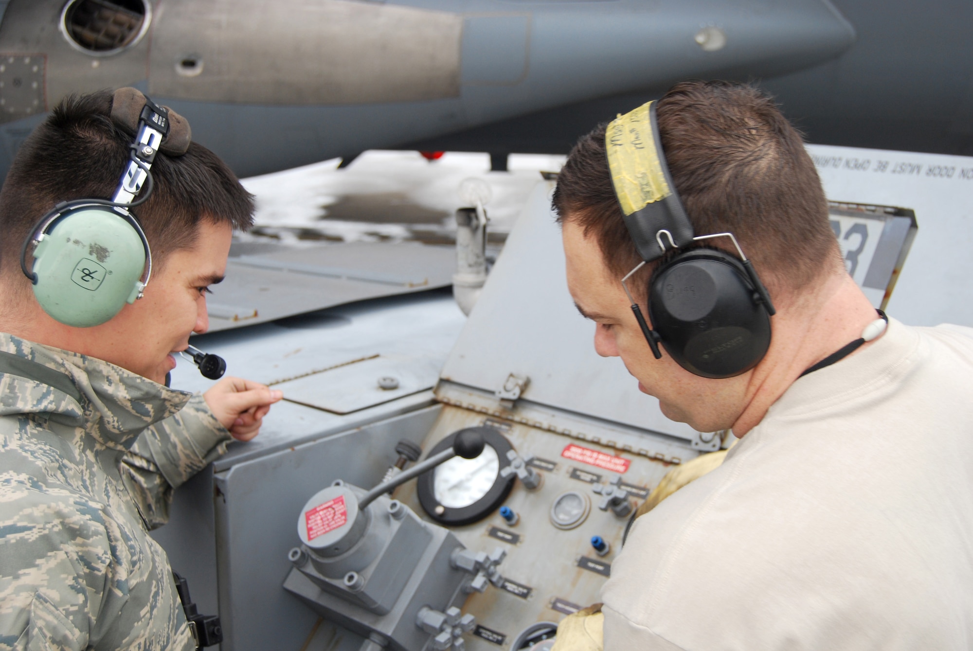 U.S. Air Force Master Sgt. Timothy Bugg and Tech. Sgt. Matthew Smith, from the 733rd Air Mobility Squadron, operate the jack manifold, controlling the rate and angle of ascent during C-17 Globemaster III airlift aircraft jack training on Kadena Air Base, Japan. The 733rd AMS maintenance flight's training opportunities are dictated by Kadena's en-route mission flow. With most aircraft stopping for less than a day, they must take advantage of every stopover to remain mission ready. (U.S. Air Force courtesy photo)