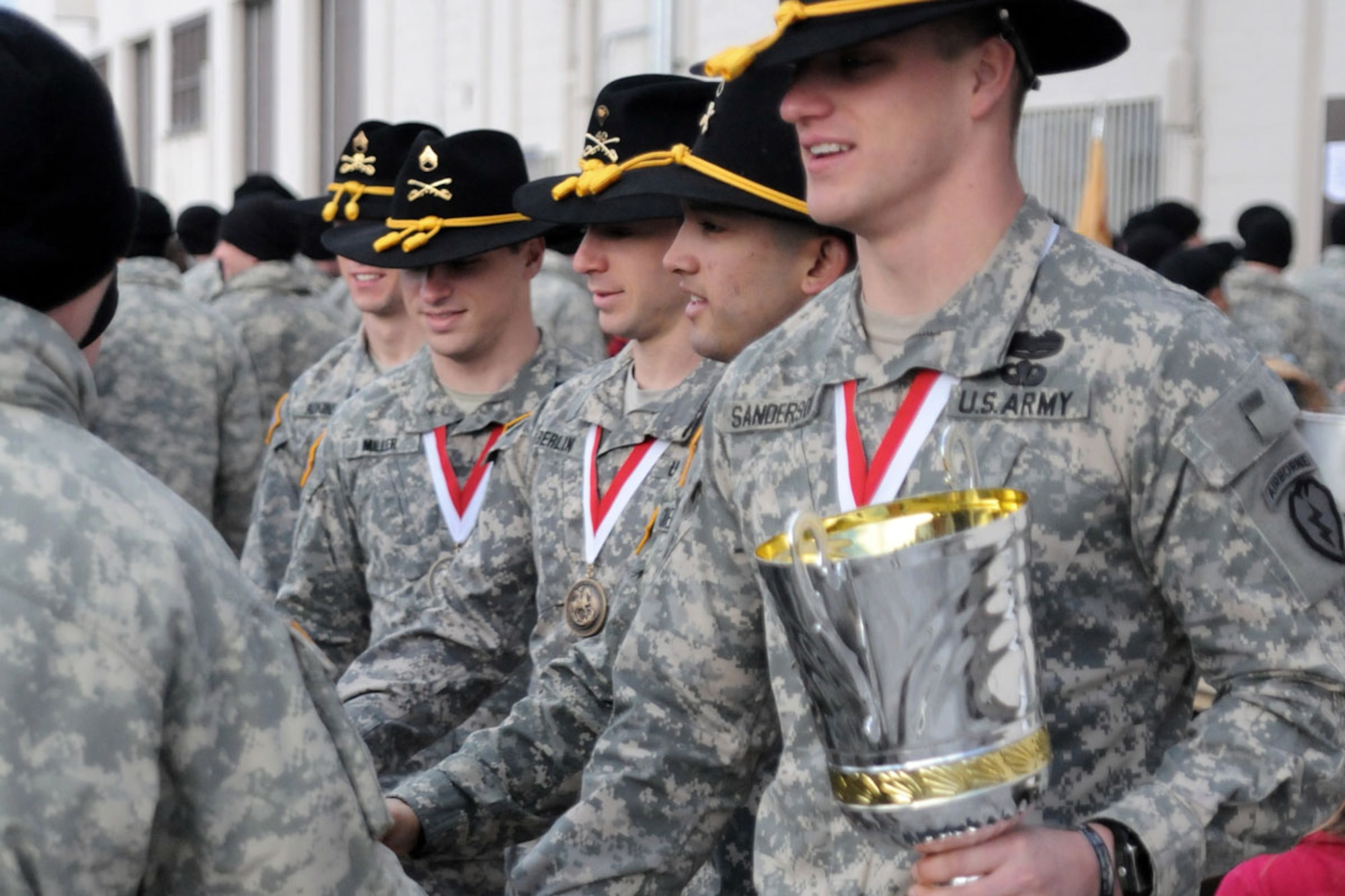 Gainey Cup champions with the 1st Squadron (Airborne), 40th Cavalry Regiment, receive congratulatory handshakes from their comrades during a ceremony to honor their achievement Saturday at JBER. (U.S. Army photo/Staff Sgt. Jeffrey Smith)