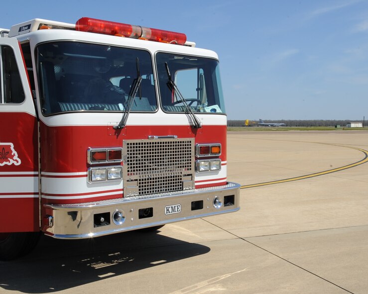 A fire truck sits on the flightline as a B-52H Stratofortress lands in the background during an aircraft egress exercise on Barksdale Air Force Base, La., March 14. The exercise was conducted to ensure 2nd Civil Engineer Squadron firefighters are mission ready in the event of a real world emergency. (U.S. Air Force photo/Senior Airman Sean Martin)