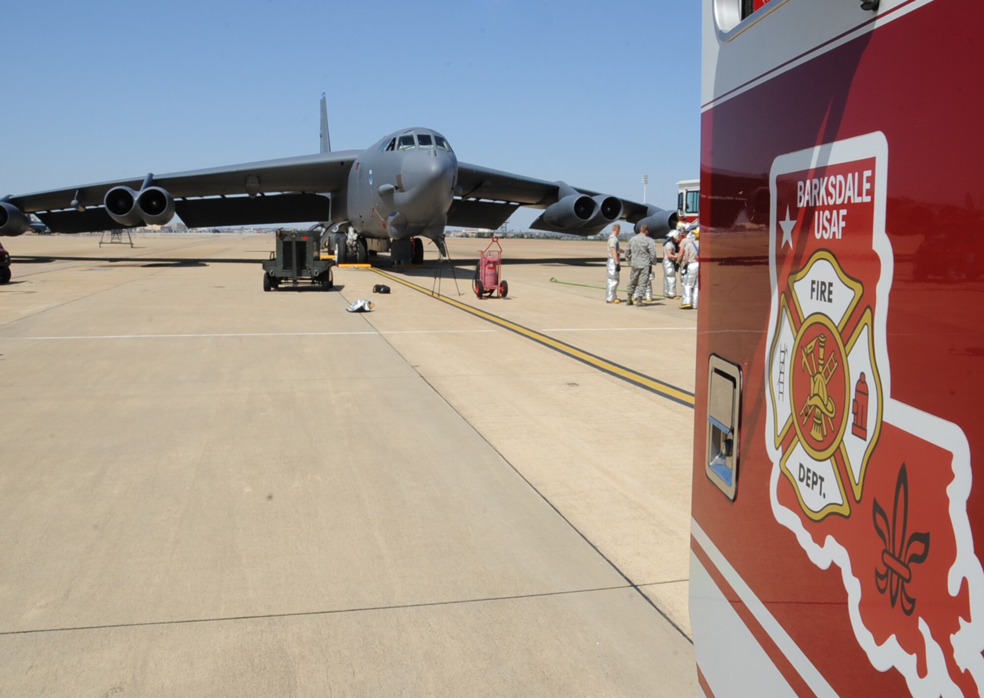 Fire fighters from the 2nd Civil Engineer Squadron regroup after an aircraft egress exercise Barksdale Air Force Base, La., March 14. 2 CES firefighters conduct this type training monthly to ensure they are mission ready at all times. (U.S. Air Force photo/Senior Airman Sean Martin)