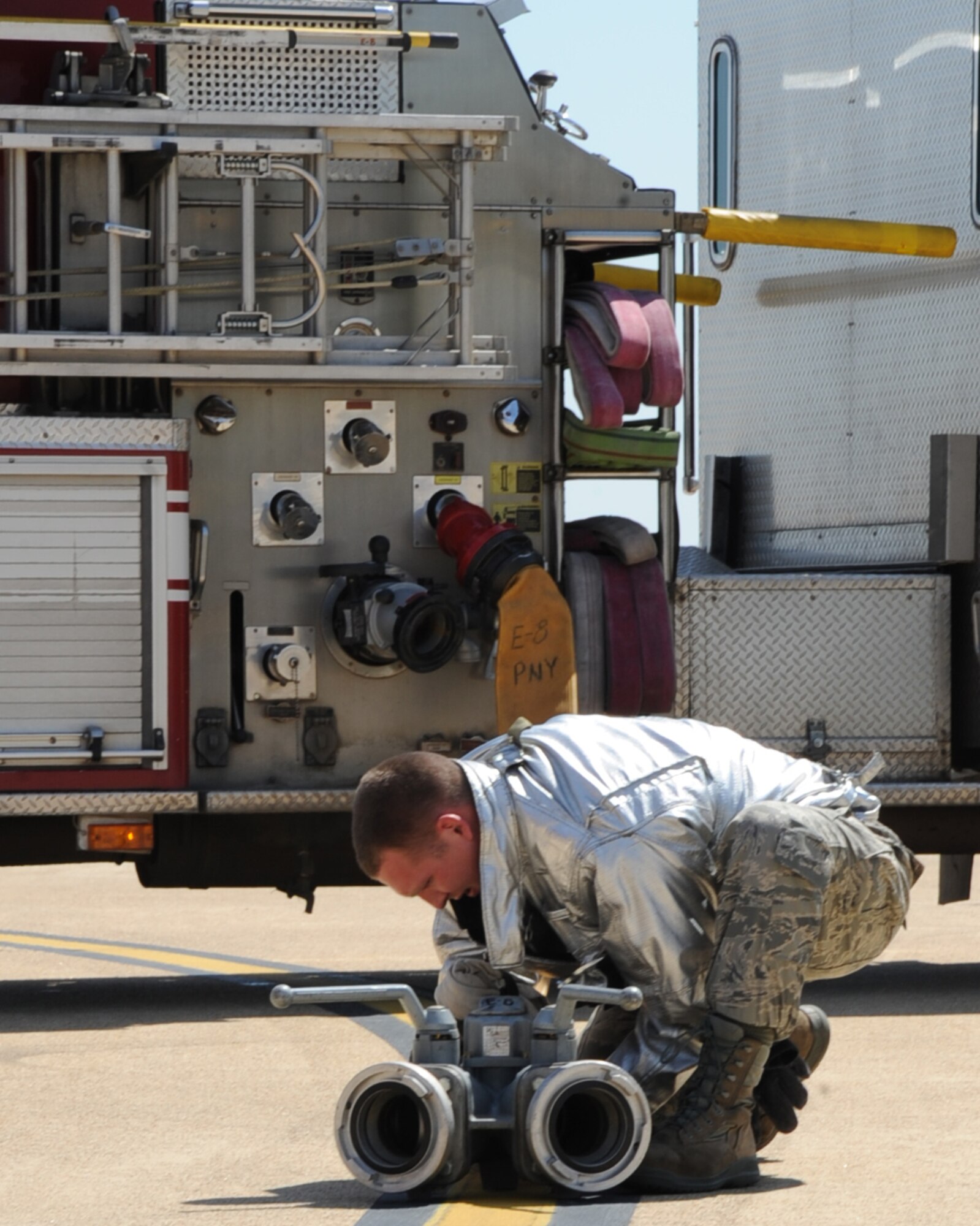 Senior Airman Wayne Miller, 2nd Civil Engineer Squadron driver and operator, attaches a hose to a coupling during an aircraft egress exercise on Barksdale Air Force Base, La., March 14. The training was held to provide firefighters hands-on training with their tools and equipment, allowing them to become proficient at their craft.  (U.S. Air Force photo/Senior Airman Sean Martin)