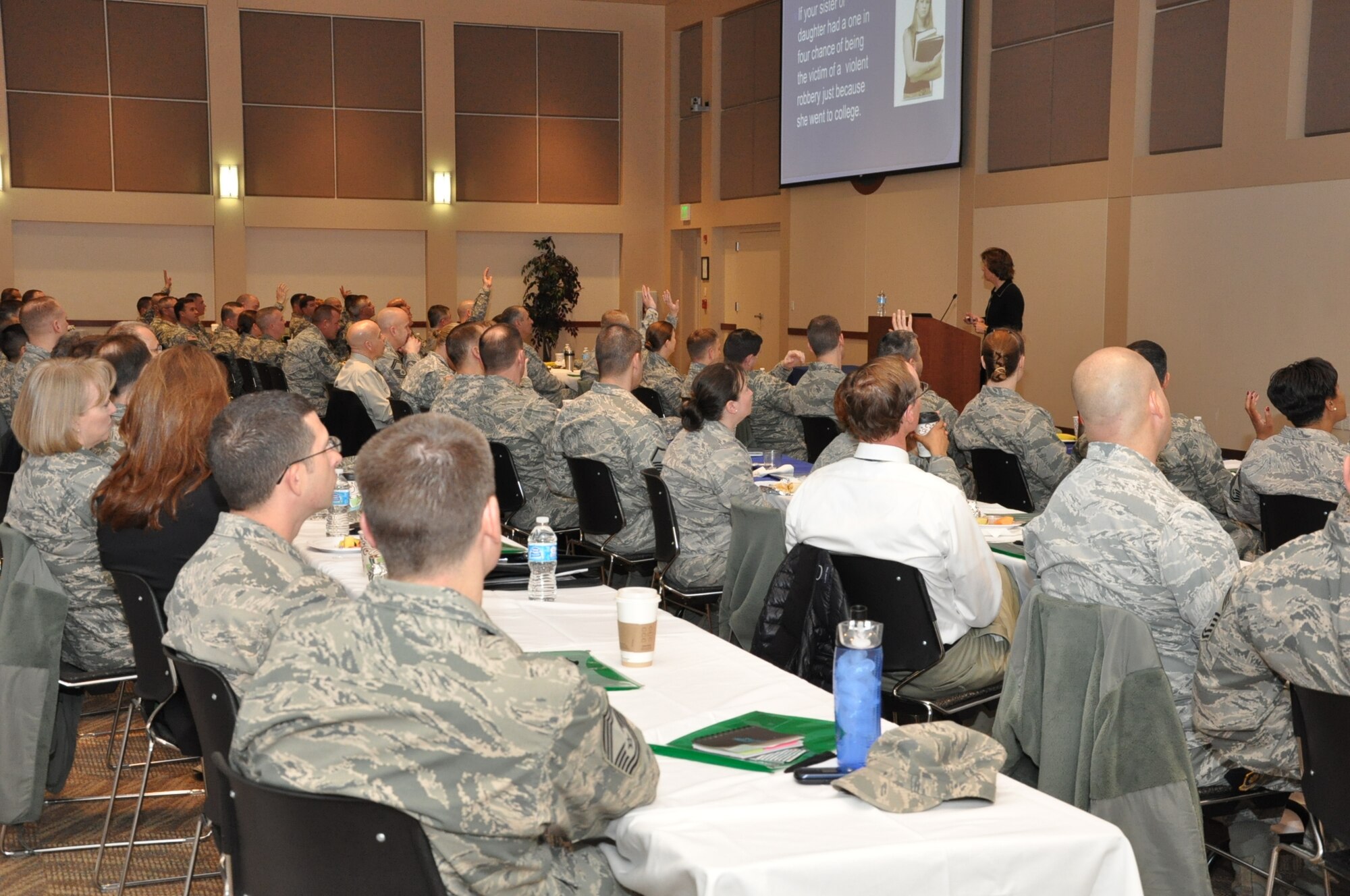 People raise their hands in response to a question from Anne Munch, a consultant and an advocate for victims of domestic violence, sexual assault and stalking, March 13, 2013, in the Leadership Development Center on Buckley Air Force Base, Colo. Munch provided insight for more than 150 service member and civilian leaders into how they can better cultivate an environment of intolerance for sexual assault. (U.S. Air Force photo by Staff Sgt. Kali L. Gradishar/Released)