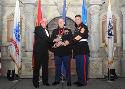 Retired Marine Sgt. Maj. Harold G. Overstreet, 12th Sergeant Major of the Marine Corps, and Sgt. Maj. Gary Tolar, U.S. Marine Corps 4th Reconnaissance Battalion inspector-instructor sergeant major, present Chief Warrant Officer 2 Michael Skinta, 4th Reconnaissance Battalion, with the Marine company grade officer of the year award.