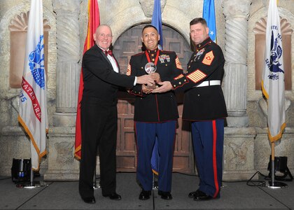 Retired Marine Sgt. Maj. Harold G. Overstreet, 12th Sergeant Major of the Marine Corps, and Sgt. Maj. Gary Tolar, U.S. Marine Corps 4th Reconnaissance Battalion inspector-instructor sergeant major, present Master Sgt. Ruben Villareal, 4th Reconnaissance Battalion, with the Marine small unit first sergeant of the year award.