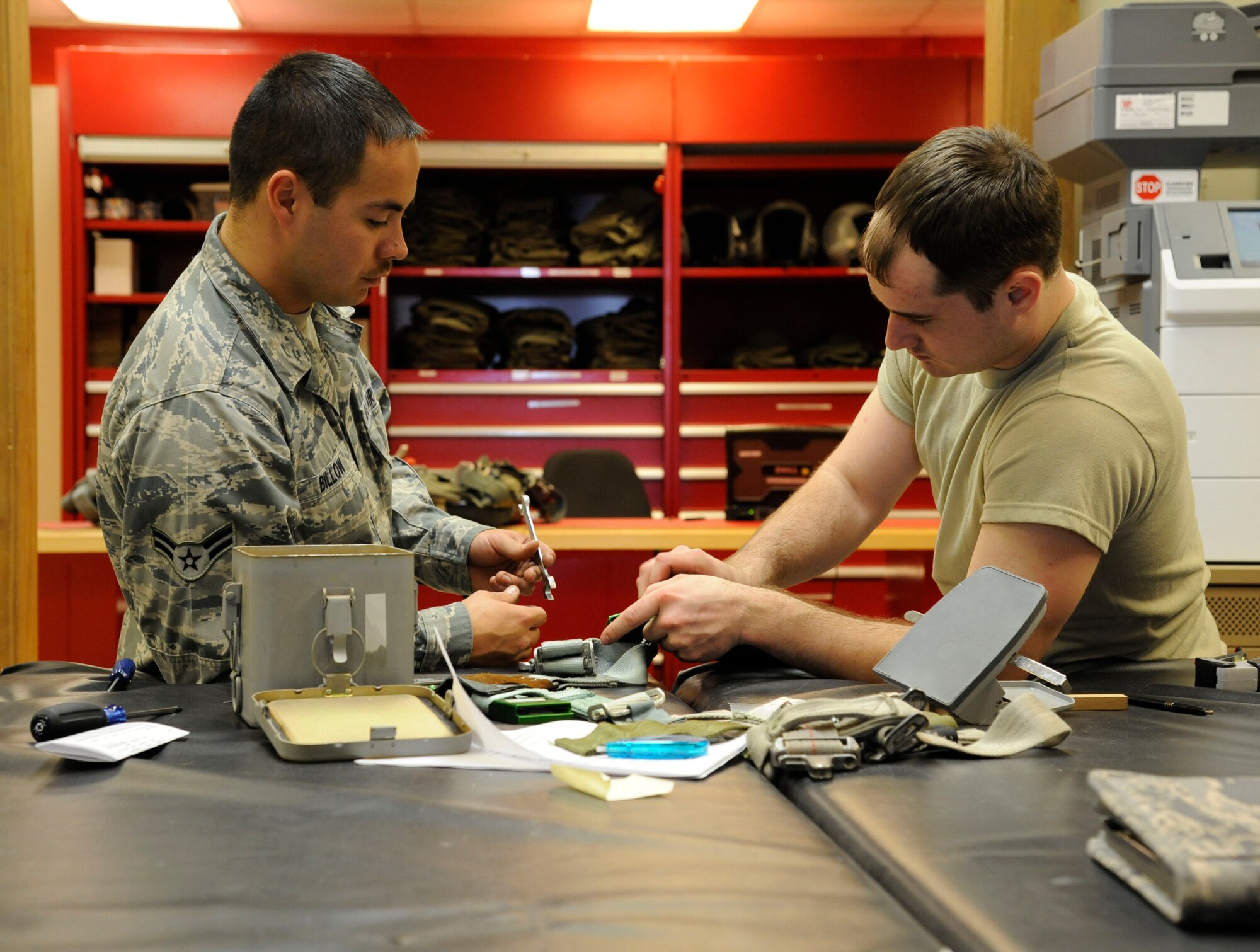 Airmen assigned to the 2nd Operations Support Squadron Aircrew Flight Equipment perform final checks before installing survival kits into B-52H Stratofortress on Barksdale Air Force Base, La., March 14. The kits include life-saving equipment in the event of an egress to include flares, sea dye, a strobe light, tourniquet, knife and candle. (U.S. Air Force photo/Airman 1st Class Andrew Moua)