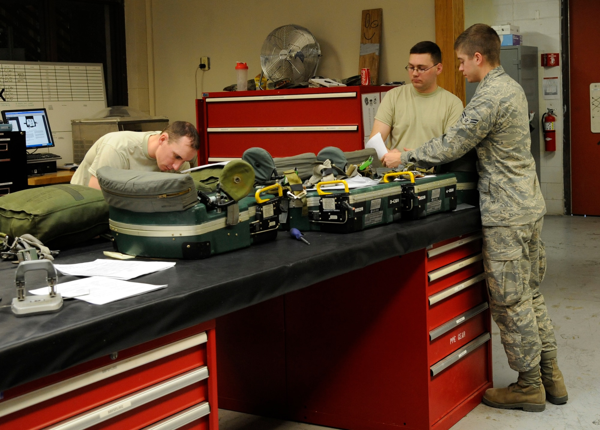 Airmen assigned to the 2nd Operations Support Squadron Aircrew Flight Equipment perform final checks before installing survival kits into B-52H Stratofortress on Barksdale Air Force Base, La., March 14. The kits include life-saving equipment in the event of an egress to include flares, sea dye, a strobe light, tourniquet, knife and candle. (U.S. Air Force photo/Airman 1st Class Andrew Moua)