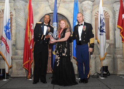 Army Maj. Gen. Adolph McQueen, U.S. Army North deputy commanding general support, and Command Sgt. Maj. Rodney Rhoades, Mission and Installation Contracting Command command sergeant major, present Jean Whitlock, 470th Military Intelligence Brigade, with the civilian non-supervisory category II of the year award.