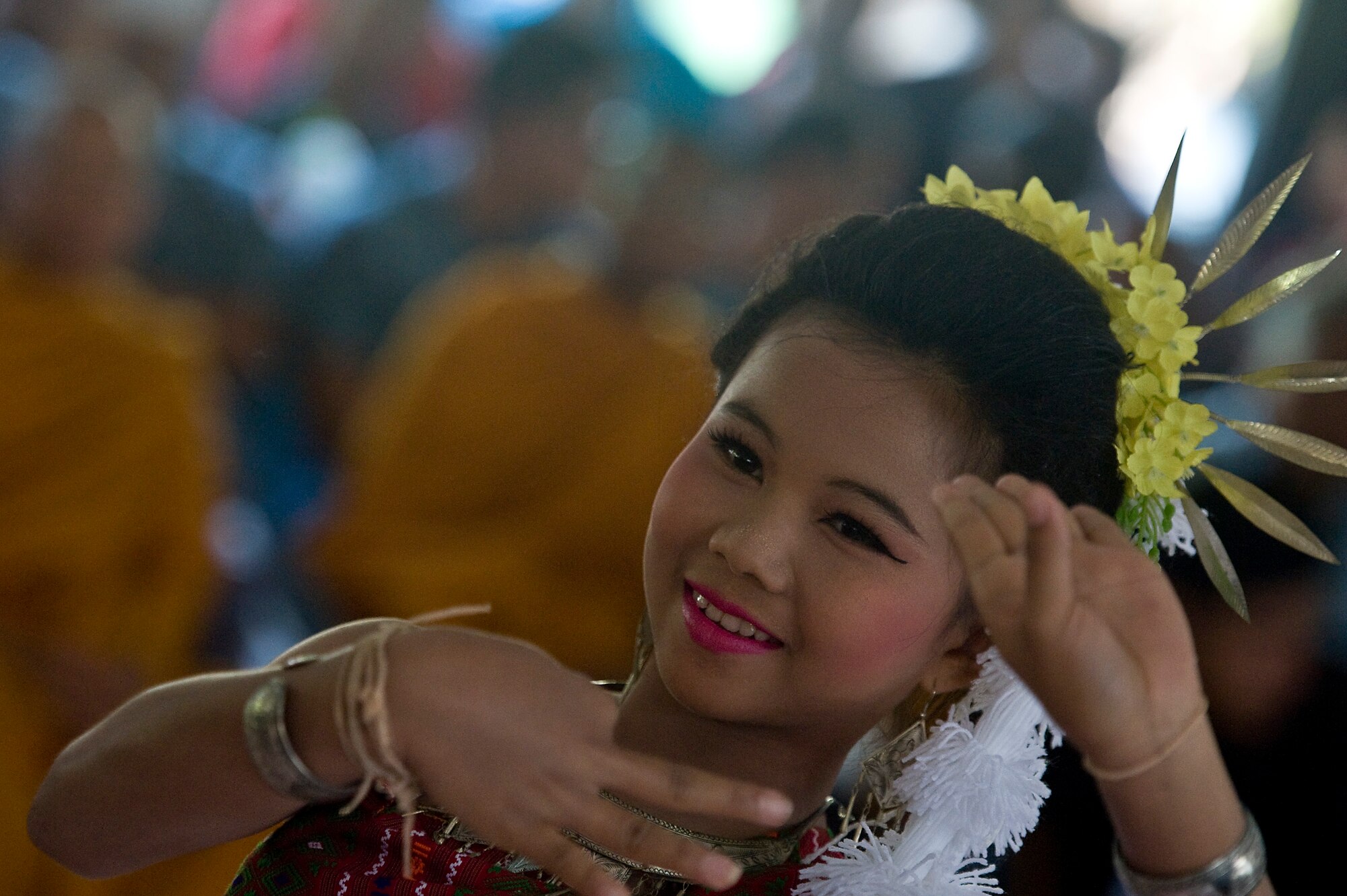 A Thai student performs a cultural dance for Cope Tiger 13 participants from the U.S. Air Force, Royal Thai Air Force and Republic of Singapore Air Force during a multilateral visit to Ban Palai School in Nakhon Ratchasima Province, Thailand, March 13, 2013. Airmen from each country donated computer equipment, school supplies, and athletic gear to the school during the multilateral engagement. The CT13 exercise directors from each country also worked on a hand-painted mural and planted cassia tree saplings to symbolize their commitment to multilateral growth and prosperity. More than 300 U.S. service members are participating in CT13, which offers an unparalleled opportunity to conduct a wide spectrum of large force employment air operations and strengthen military-to-military ties with two key partner nations, Thailand and Singapore. (U.S. Air Force photo/2nd Lt. Jake Bailey)
