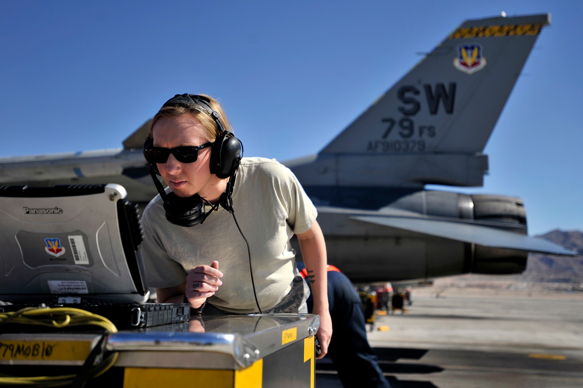U.S. Air Force Staff Sgt. Elizabeth Tyburski, 20th Communications Squadron client service technician, looks at flight aircraft data on a tough book prior to launching a 79th Fighter Squadron ‘Tigers’ F-16 Fighting Falcon during Red Flag 13-3, March 12, 2013, Nellis Air Force Base, Nev. Tyburski received the rare opportunity to launch an F-16 and experienced what it’s like to be a crew chief. (U.S. Air Force photo by Staff Sgt. Kenny Holston/Released)