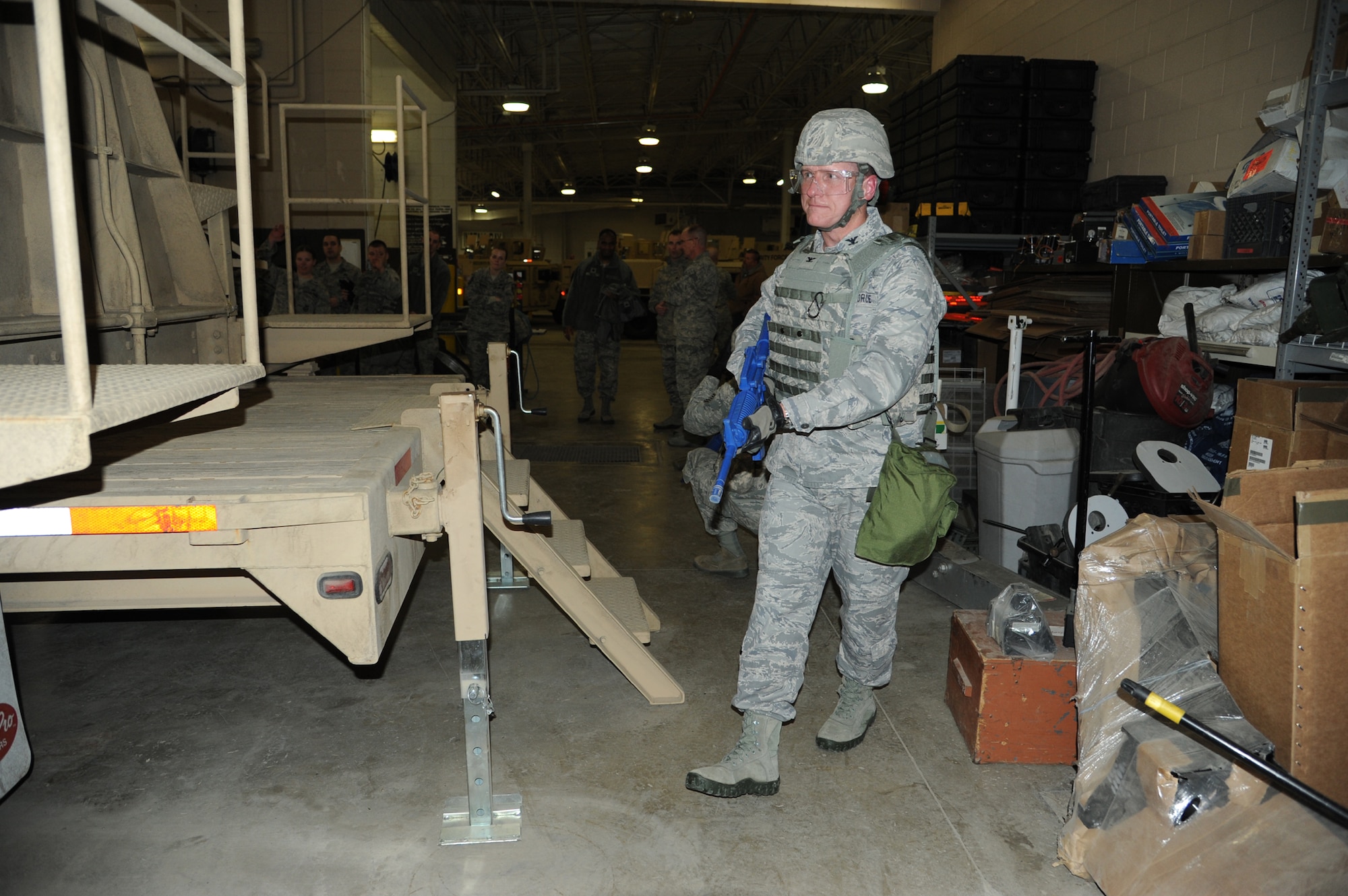 Col. Robert Stanley, 341st Missile Wing commander, performs 360-degree security after exiting the Humvee Egress Assistance Trainer on March 7. The trainer, borrowed from Camp Guernsey, Wyo., provides skills for drivers and vehicle occupants, teaching them to mitigate injuries during a vehicle rollover. (U.S. Air Force photo/Airman 1st Class Katrina Heikkinen)