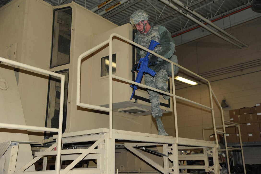 Senior Airman Gregory Pease, 341st Missile Security Forces Squadron response force leader, exits the Humvee Egress Assistance Trainer after hearing the command ‘Egress.’ Pease and members of the 341st Security Forces Squadron had the opportunity to test their maneuvering, exiting and 360-degree security skills during training March 7. (U.S. Air Force photo/Airman 1st Class Katrina Heikkinen)