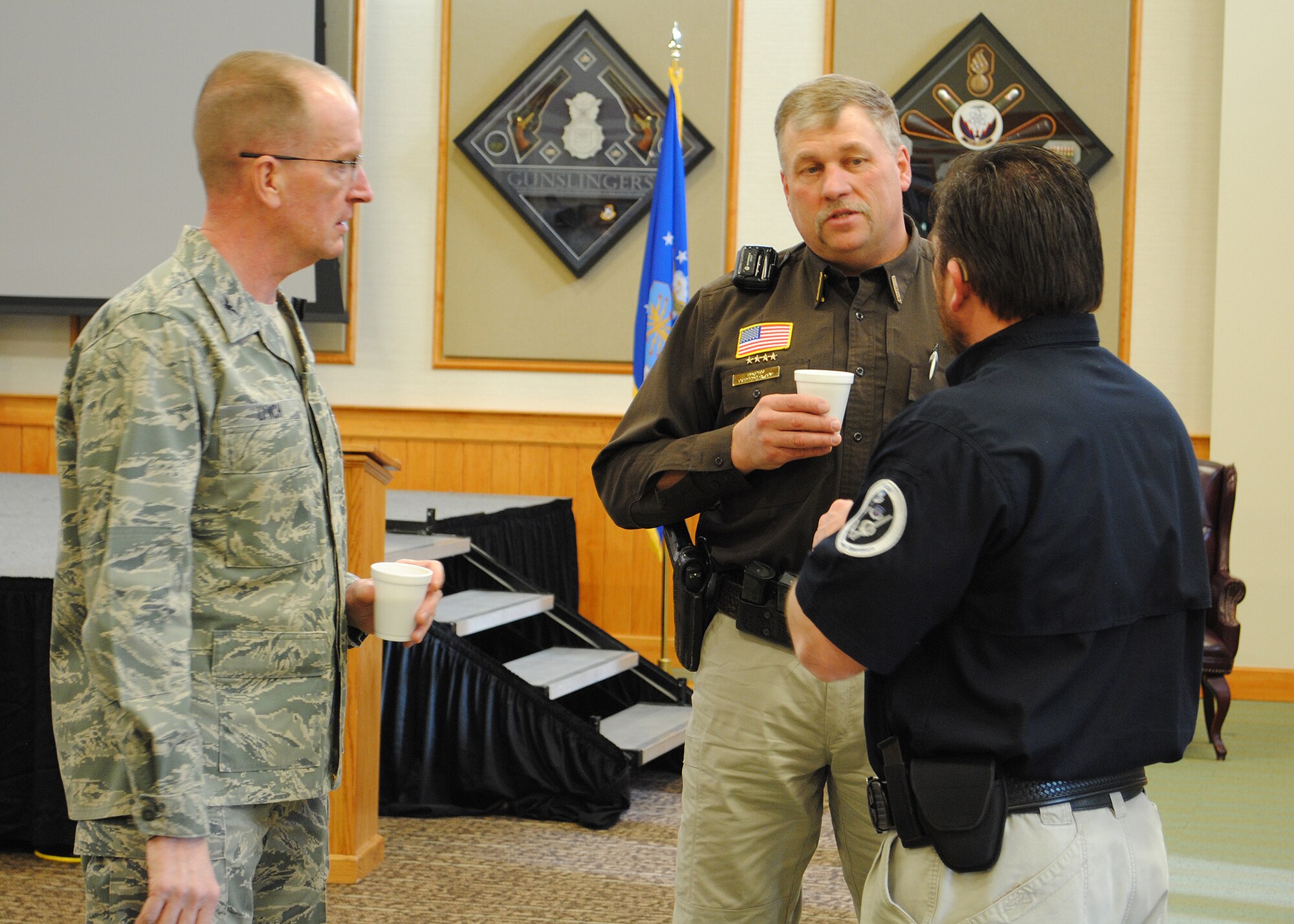Col. David Lynch, 341st Security Forces Group commander, left; Sheriff Ray Clark, Judith Basin Sherriff’s Office, center; and Brian Birdwell, 341st Missile Wing Office of Special Investigations; chat about local and base law enforcement issues before the Law Enforcement Camaraderie Day activities held at the Grizzly Bend on March 12.  This event, set up by Birdwell, replaced the second quarter local and base Law Enforcement get together.  (U.S. Air Force photo/Senior Airman Cortney Paxton)