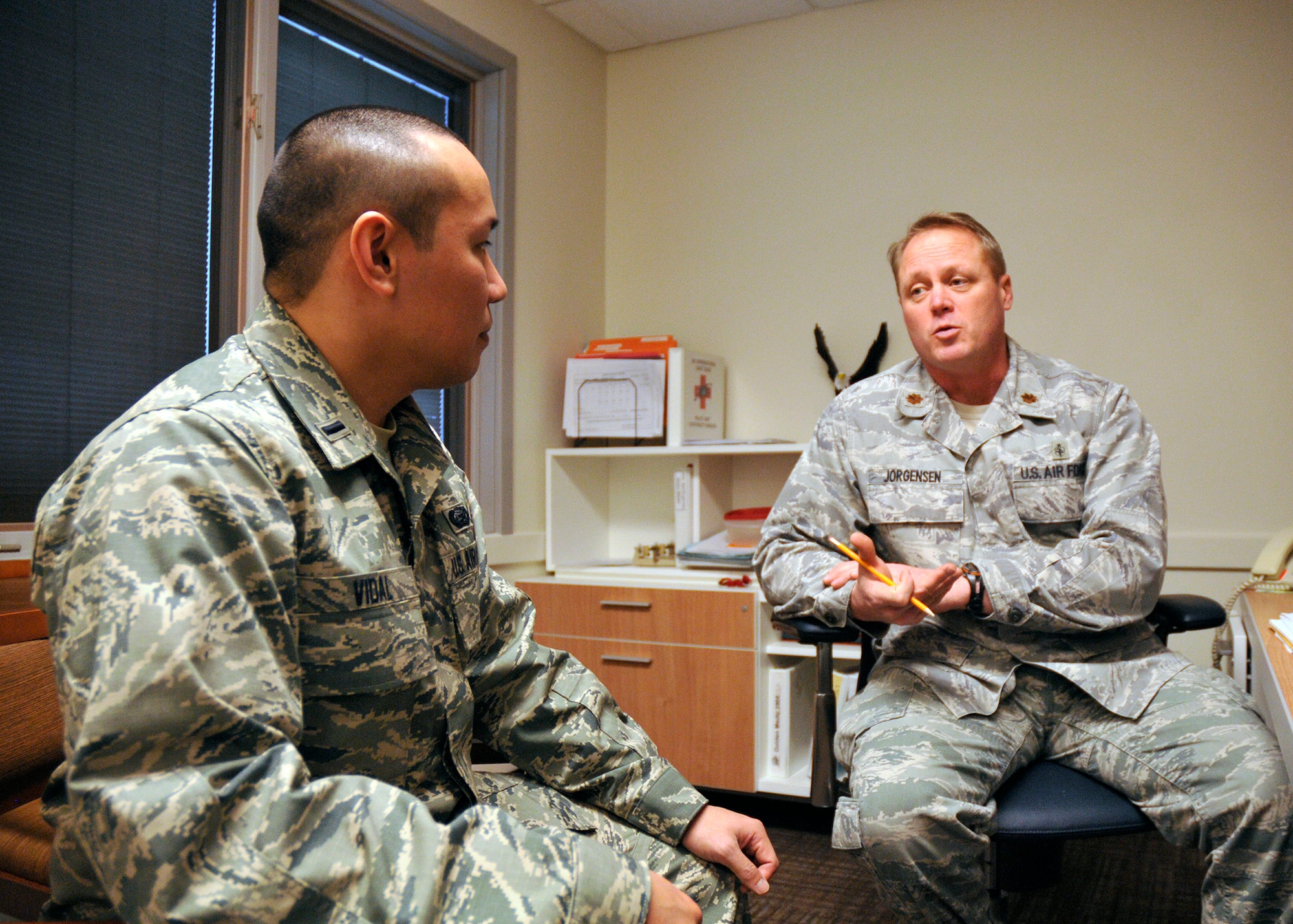 Maj. Peter Jorgensen (right), 446th Aeromedical Evacuation Squadron Health Services administrator, out of McChord Field, Wash., gives 1st Lt. Francesco Vidal III the rundown of his roles and responsibilities of being a Medical Service Corps officer with the squadron. Vidal received a direct commission into the Air Force Reserve less than two years after he completed enlisted basic training. “He seems eager and easy going, so he will be a good fit for our unit in moving forward,” Jorgensen said. “He has an administrative background, which should be very helpful with any section he gets assigned to." (U.S. Air Force photo/Master Sgt. Jake Chappelle)