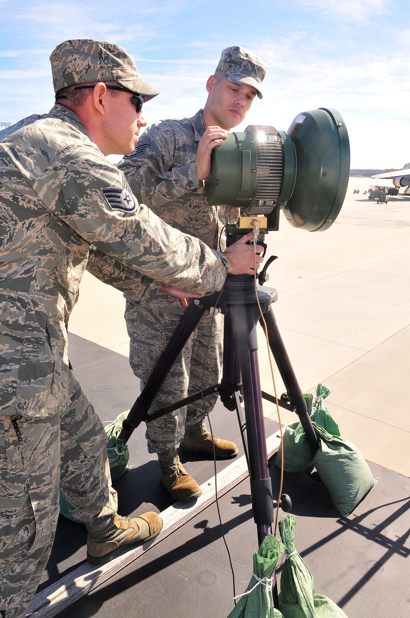 Staff Sgts. Travis Hood and Aviel Perez, 53rd CBCS cyber transport craftsmen with the Infrastructure Work Center, do a PMI (Preventive Maintenance Inspection) on an antenna of the RF (Radio Frequency) Module on Robins' flight line. (U. S. Air Force photo/Sue Sapp)