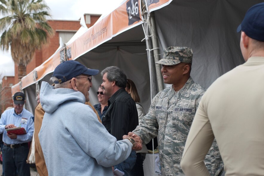 Tech. Sgt. James Wright, a recruiter with the 162nd Fighter Wing, introduces himself to a military veteran March 9 at the annual Festival of Books in Tucson, Ariz. The wing recruiting team and student flight members operated a booth at the festival to provide community service and interface with community members. (U.S. Air Force photo by Staff Sgt. Heather Davis)