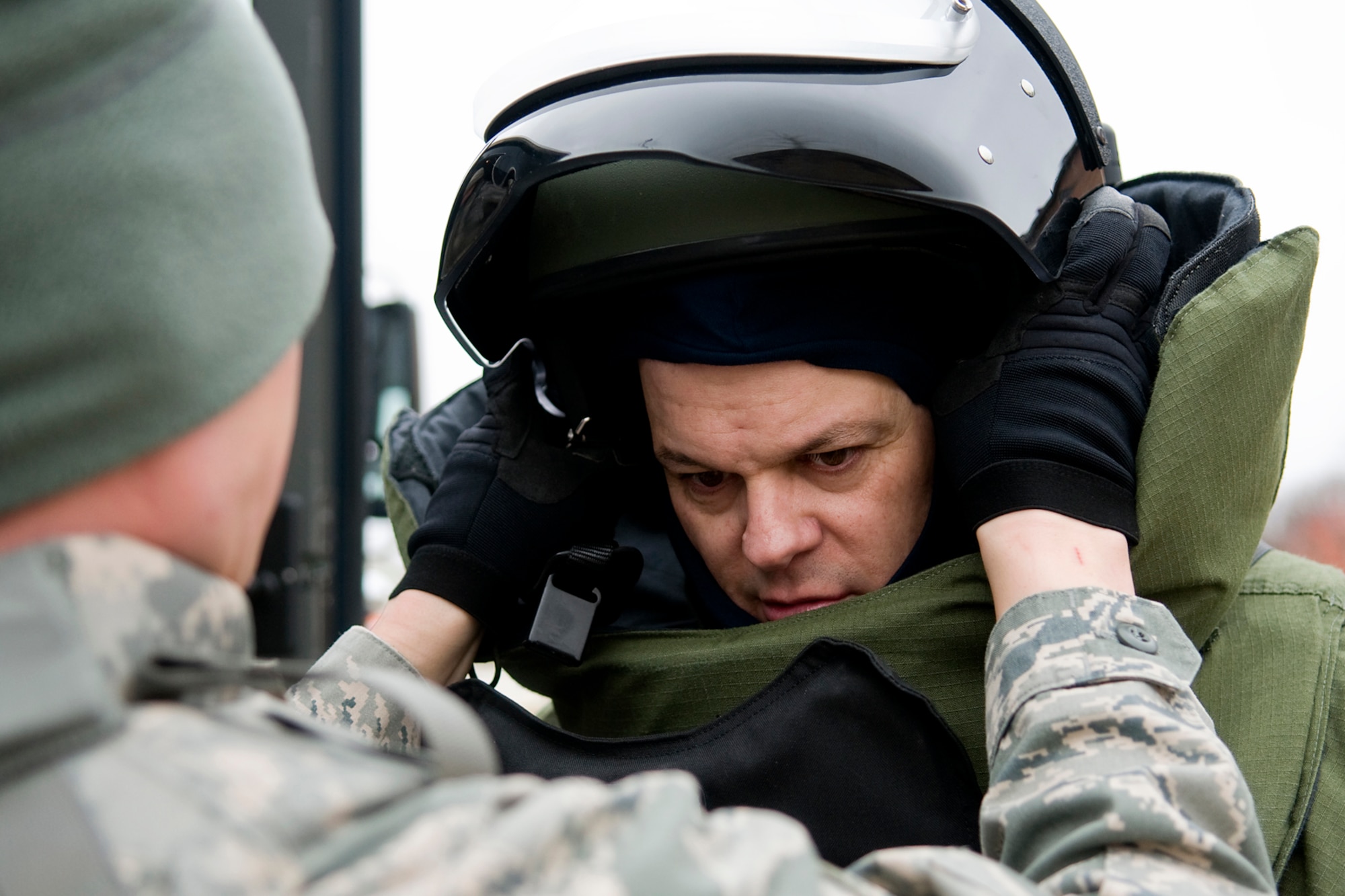 GRISSOM AIR RESERVE BASE, Ind. -- Airman 1st Class Wyatt Shannon helps Tech. Sgt. Robert Woods put on a bomb suit during an explosives ordnance disposal exercise here Feb. 21. Both Airmen are assigned to the 434th Civil Engineer Squadron as explosives ordnance disposal technicians. (U.S. Air Force photo/Tech. Sgt. Mark R. W. Orders-Woempner)
