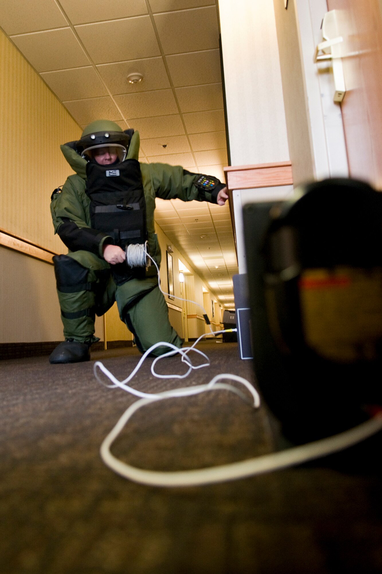 GRISSOM AIR RESERVE BASE, Ind. -- Tech. Sgt. Robert Woods, 434th Civil Engineer Squadron explosives ordnance disposal technician, runs a data transfer cable from a portable x-ray device to a nearby computer during a recent EOD exercise here Feb. 21. EOD technicians use portable x-ray technology to determine the composition of various explosive threats and how best to render them safe. (U.S. Air Force photo/Tech. Sgt. Mark R. W. Orders-Woempner)
