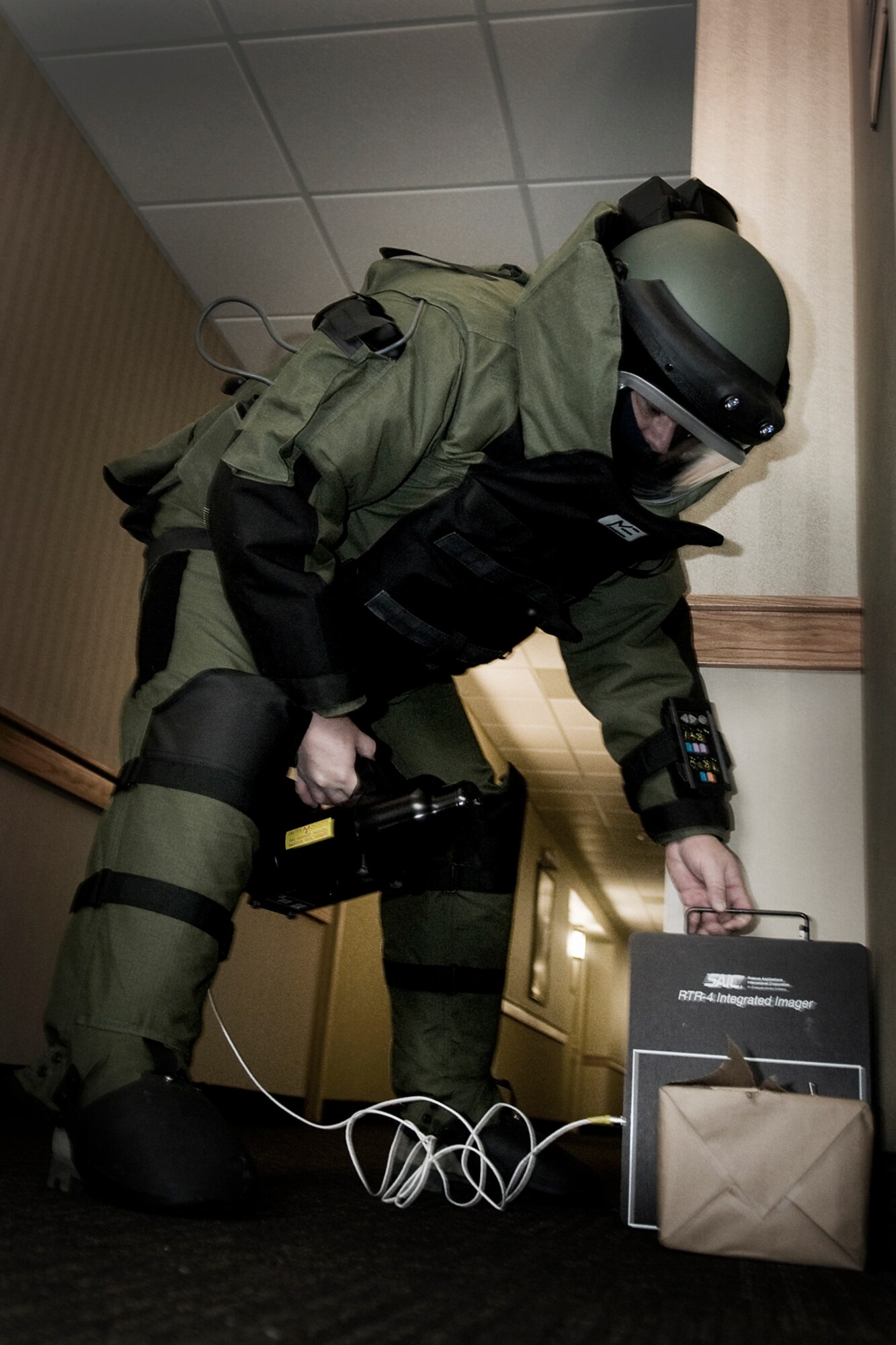 GRISSOM AIR RESERVE BASE, Ind. -- Tech. Sgt. Robert Woods, 434th Civil Engineer Squadron explosives ordnance disposal technician, places x-ray equipment around a simulated improvised explosive device during an EOD exercise held here Feb. 21. EOD technicians use portable x-ray technology to determine the composition of various explosive threats and how best to render them safe. (U.S. Air Force photo/Tech. Sgt. Mark R. W. Orders-Woempner)
