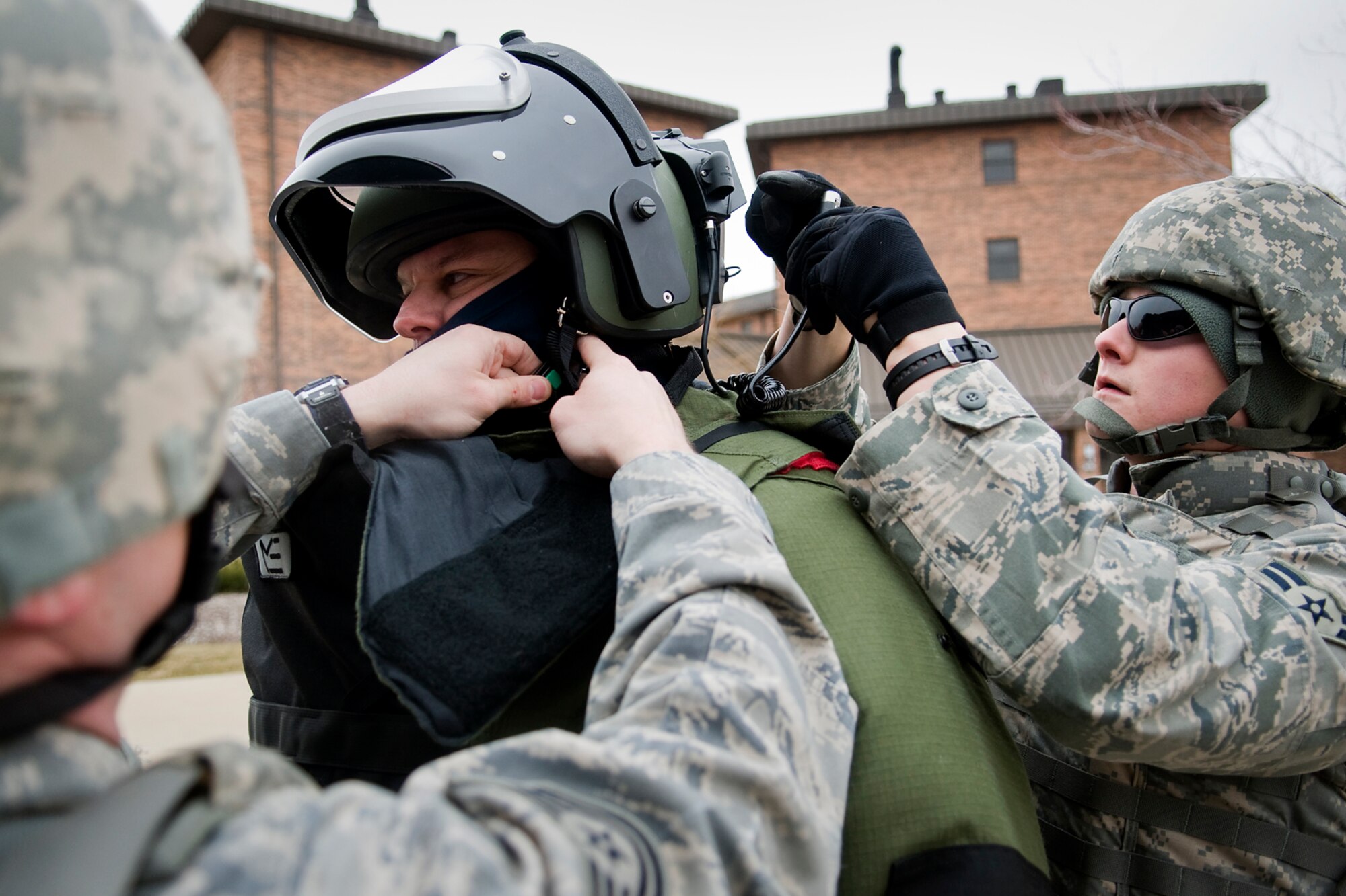 GRISSOM AIR RESERVE BASE, Ind. -- Tech. Sgt. Justin Krautkremer, left, and Airman 1st Class Wyatt Shannon, right, help Tech. Sgt. Robert Woods with his bomb suit during an explosive ordnance disposal training exercise here Feb. 21. All three are EOD technicians assigned to the 434th Civil Engineer Squadron. (U.S. Air Force photo/Tech. Sgt. Mark R. W. Orders-Woempner)
