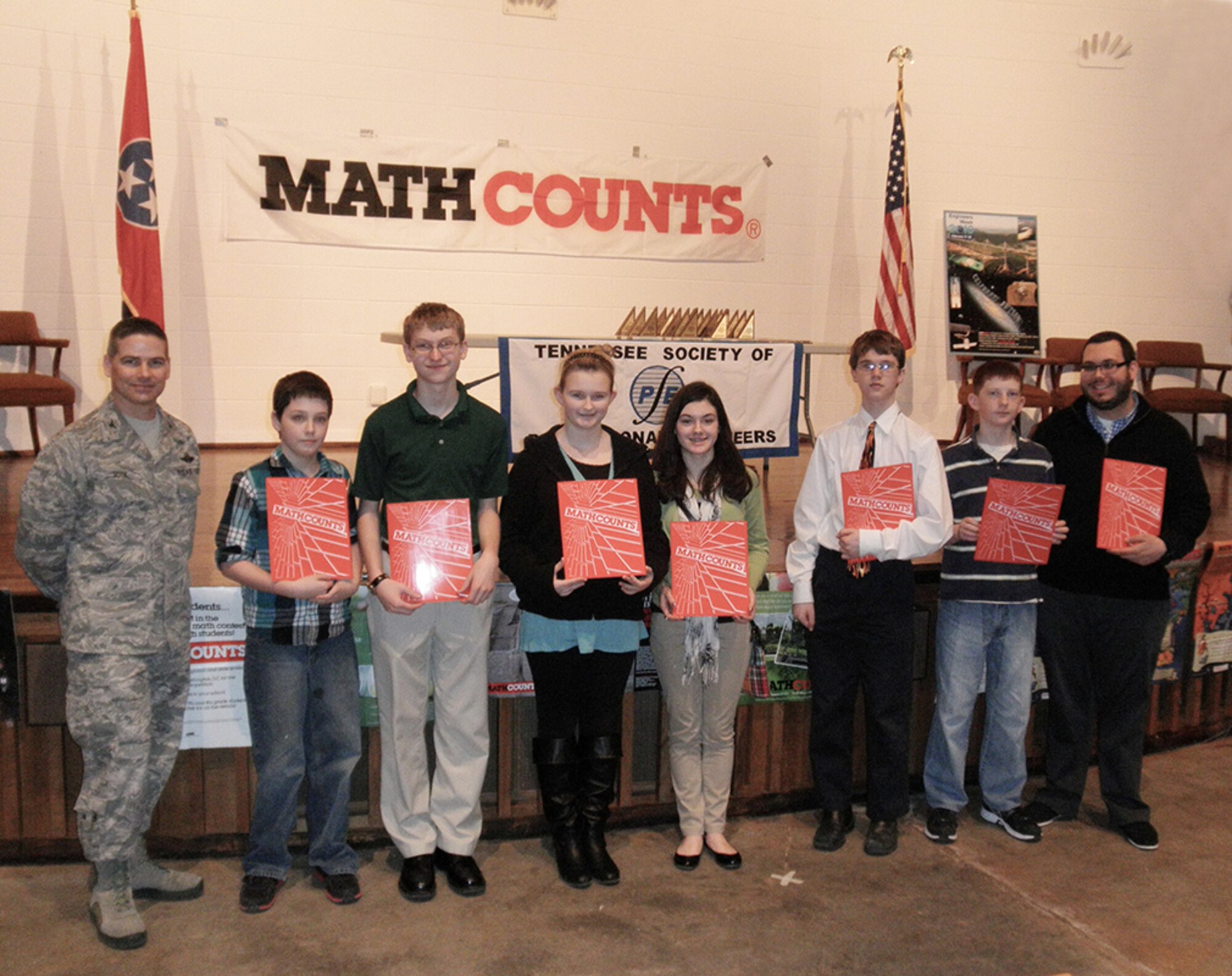 Arnold Engineering Development Complex Commander, Col. Raymond Toth stands with West Middle School’s winning team, including (from left)  Cameron Haley, 7th grader; James Johnson, 8th grader; Kelsi Burt, 8th grader; Morgan Anderson,  8th grader; Nathan Marble, 8th grader; Sam Daugherty, 7th grader; and  Chris King , coach. (Photo provided)