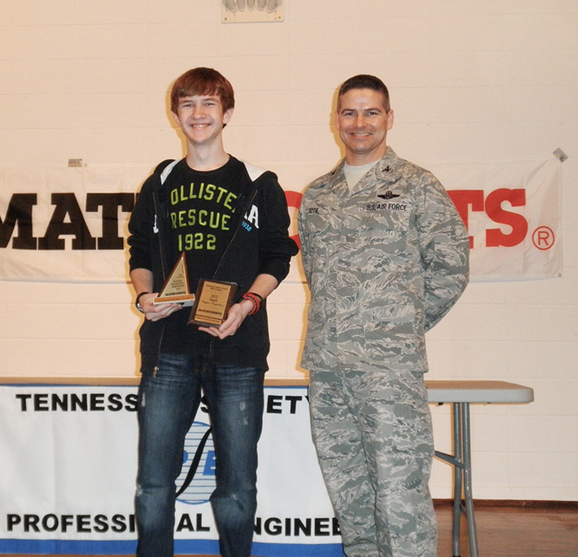 From left, Arnold Engineering Development Complex Commander, Col. Raymond Toth with East Middle School’s Andrew Mares, third place individual winner. (Photo provided) 