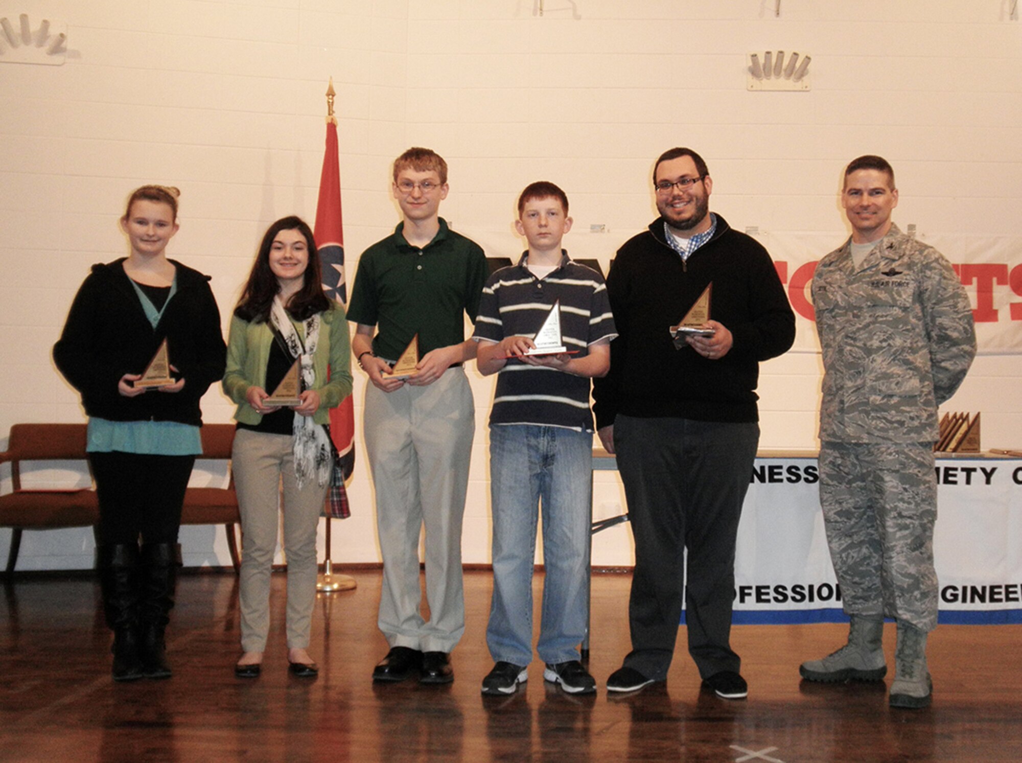 From left to right, West Middle School 8th graders Kelsi Burt, Morgan Anderson and James Johnson, West Middle School 7th grader Sam Daugherty, and West Middle School coach Chris King, pose with AEDC Commander Col. Raymond Toth after Tullahoma West Middle School’s team earned third place in the local 2013 MathCounts competition held Feb. 16 at the University of Tennessee Space Institute. (Photo provided)