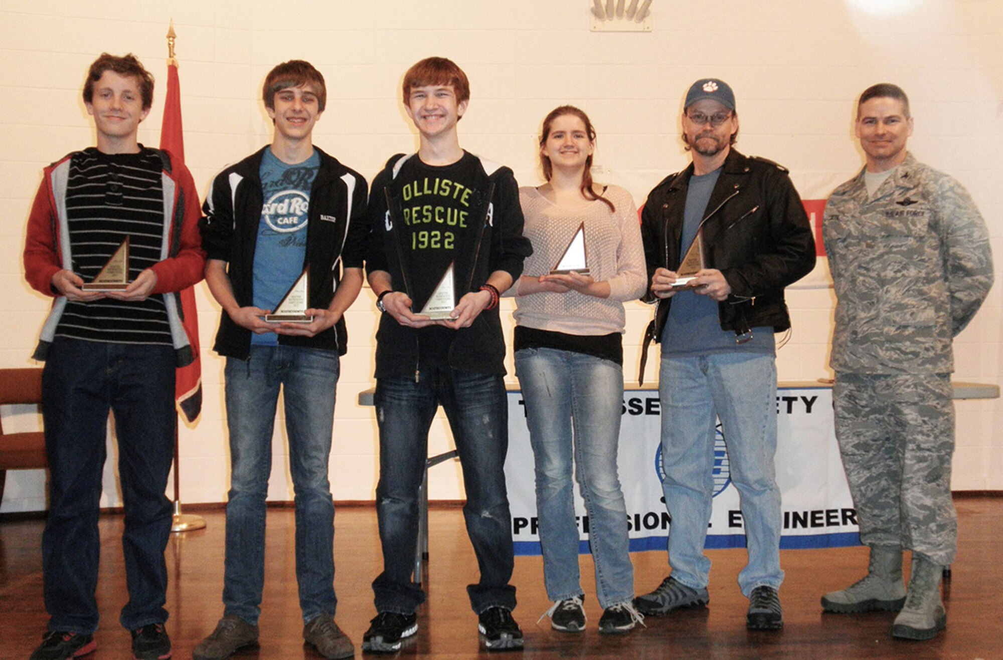 From left to right eighth graders William Kuebitz, Spencer Baxter, Andrew Mares and Kathryn Brosemer and Trent Stout, coach, pose with AEDC Commander Col. Raymond Toth after the East Middle School team earned first place in the local 2013 MathCounts competition held Feb. 16 at the University of Tennessee Space Institute. (Photo provided) 
