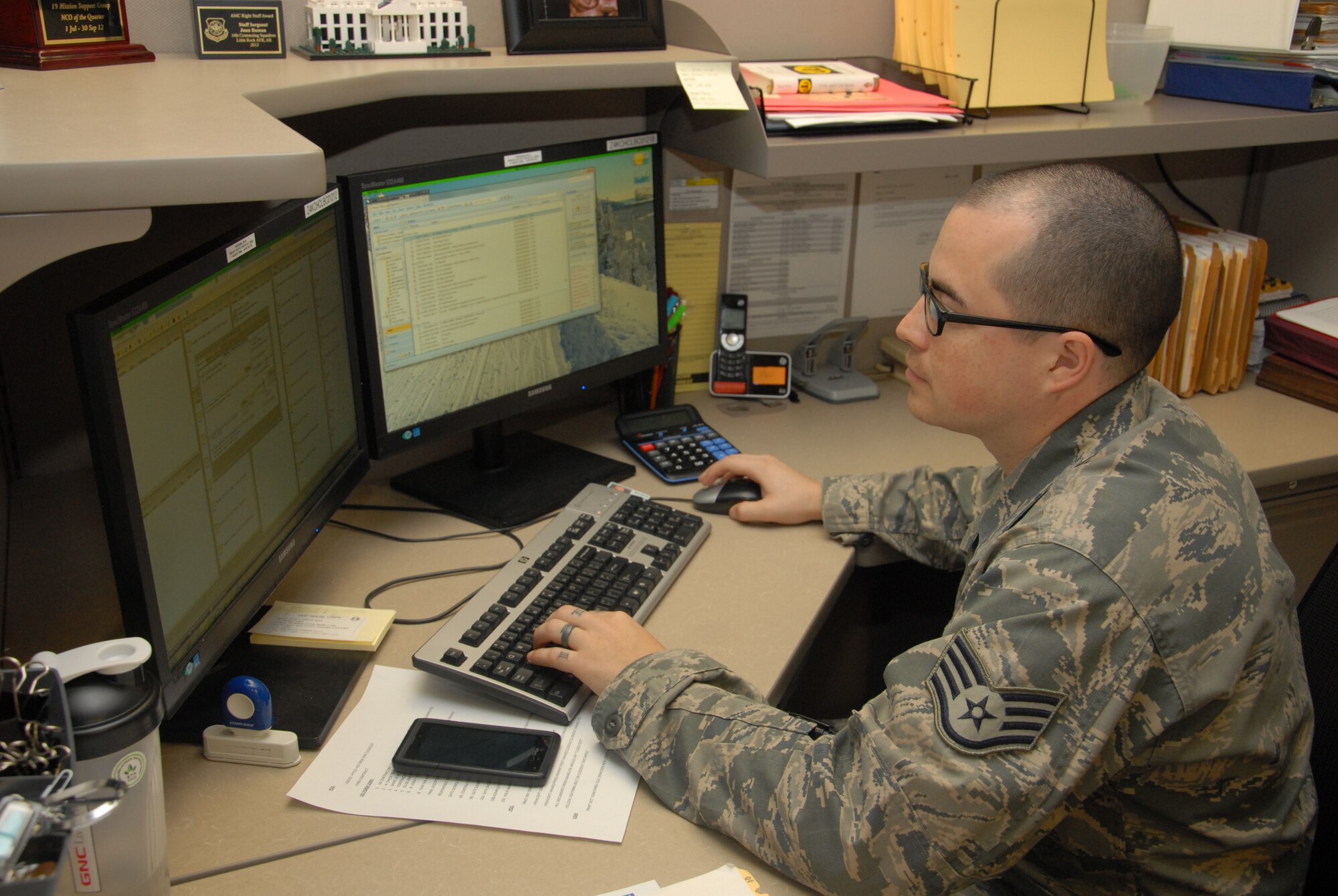 Staff Sgt. Juan Roman, a 19th Contracting Squadron contracting specialist, works on closing out fiscal year 2012 contracts March 12, 2013, at Little Rock Air Force Base, Ark. Roman led a seven member team to a $10 million end of fiscal year, with 70 percent of his team having less than two years of experience. This accomplishment was one of the reasons Roman earned the Right Stuff Award. (U.S. Air Force photo by Senior Airman Regina Agoha)  