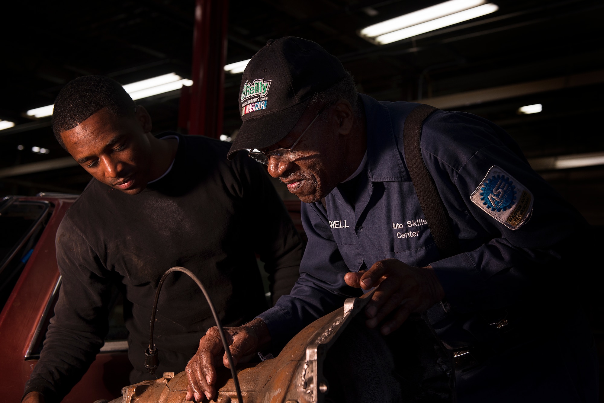 Parnell Fisher helps Staff Sgt. Bobby Johnson, 19th Logistic Readiness Squadron passenger terminal fleet supervisor, Feb. 26, 2013, in the Auto Hobby shop, at Little Rock Air Force Base, Ark. Fisher, the shop’s lead mechanic and a decorated war hero, is known to tell stories on a variety of topics ranging from Air Force history to healthy living. (U.S. Air Force photo by Staff Sgt. Russ Scalf)