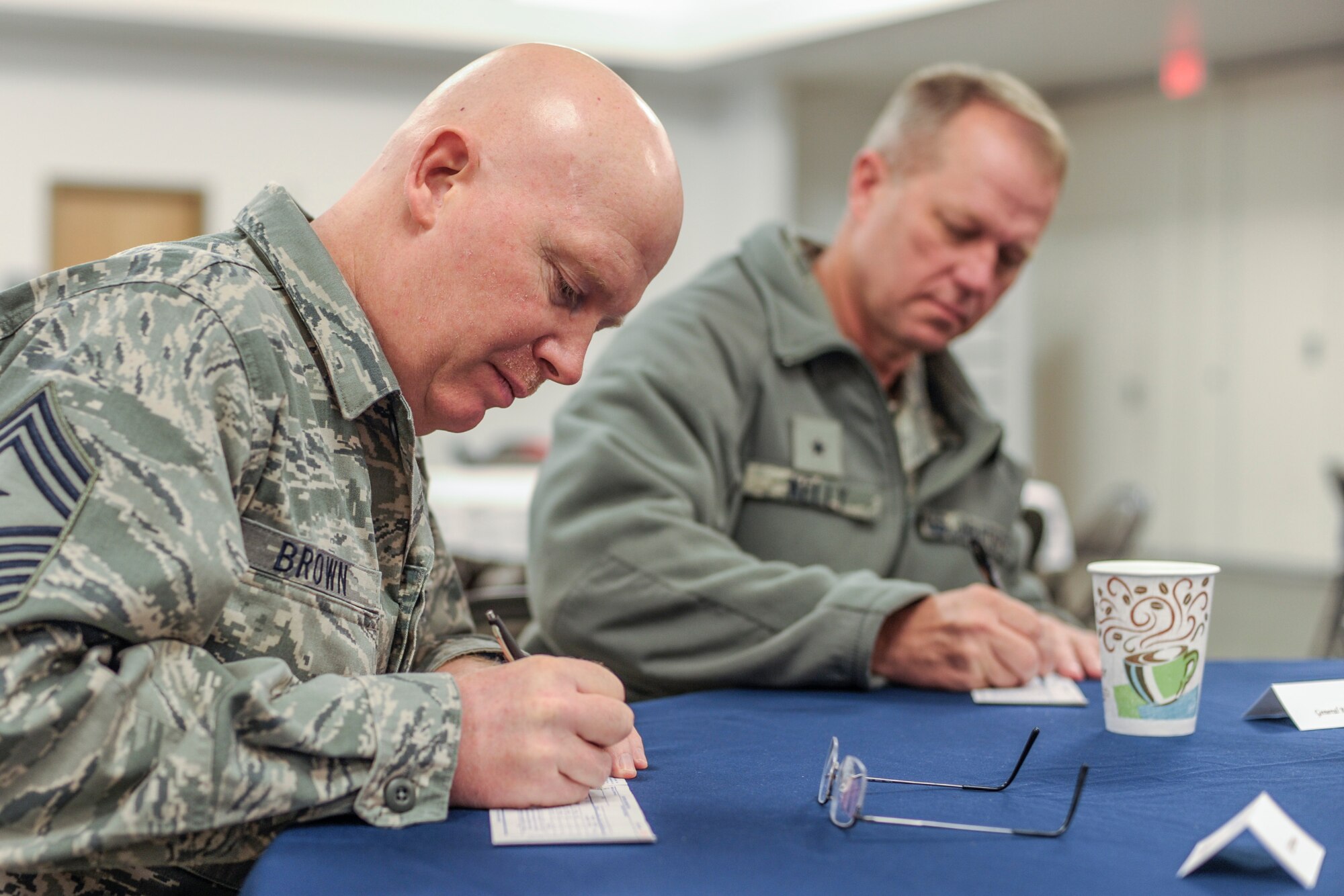 U.S. Air Force Command Chief Master Sgt. Jeffery Brown, 354th Fighter Wing command chief, and Brig. Gen. Mark Kelly, 354th FW commander, sign Air Force Assistance Fund payroll deduction forms at the AFAF fundraiser kickoff at the base chapel March 11, 2013, Eielson Air Force Base, Alaska. Donations to the campaign lend critical support to fellow Airmen and their families. For more information, contact your unit AFAF Key Worker.  (U.S. Air Force photo/Airman 1st Class Peter Reft)