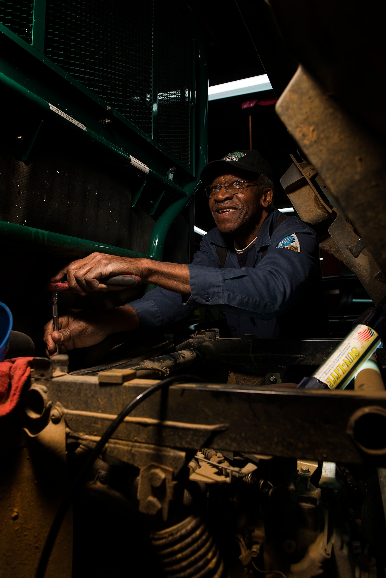 Parnell Fisher works on a vehicle at the Little Rock Air Force Base Auto Hobby shop Feb. 26, 2013. Fisher retired from the Air Force in 1977, and now works at the facility as the lead mechanic. (U.S. Air Force photo by Staff Sgt. Russ Scalf)