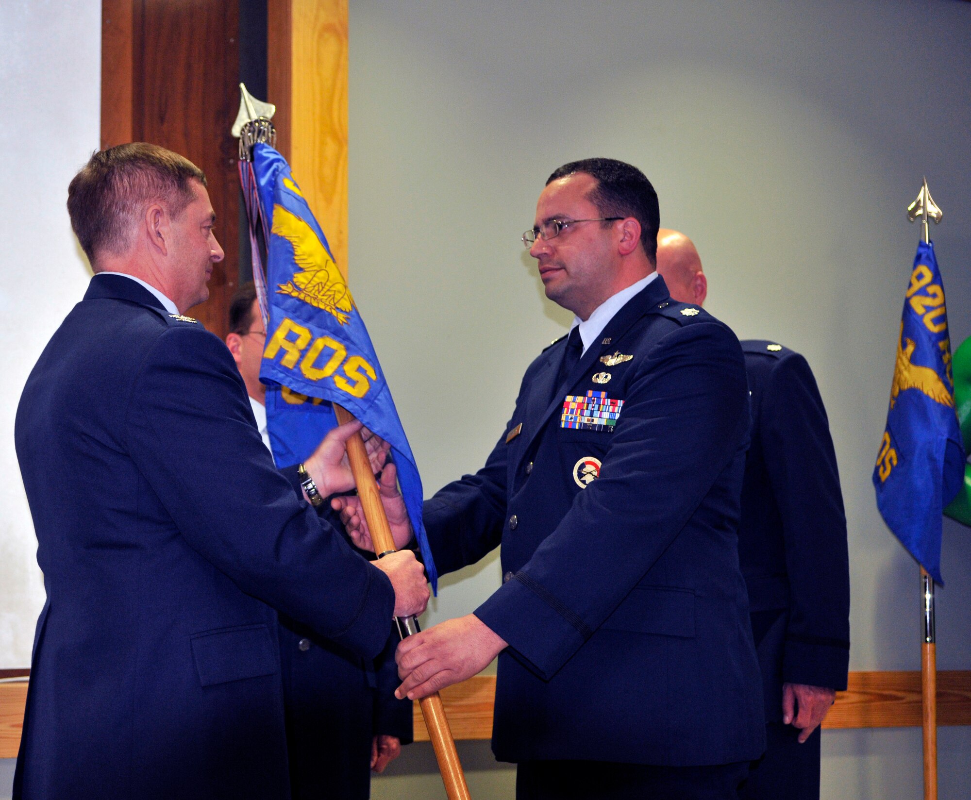 Lt. Col. Alexander DeGracia accepts the 39th Rescue Squadron’s guideon from Col. Mark Blalock, 920th Operations Group commander. DeGracia took the reins of the 39th Rescue Squadron during a change of command ceremony held over the March Unit Training Assembly. (U.S. Air Force photo/Tech.Sgt. Peter Dean)