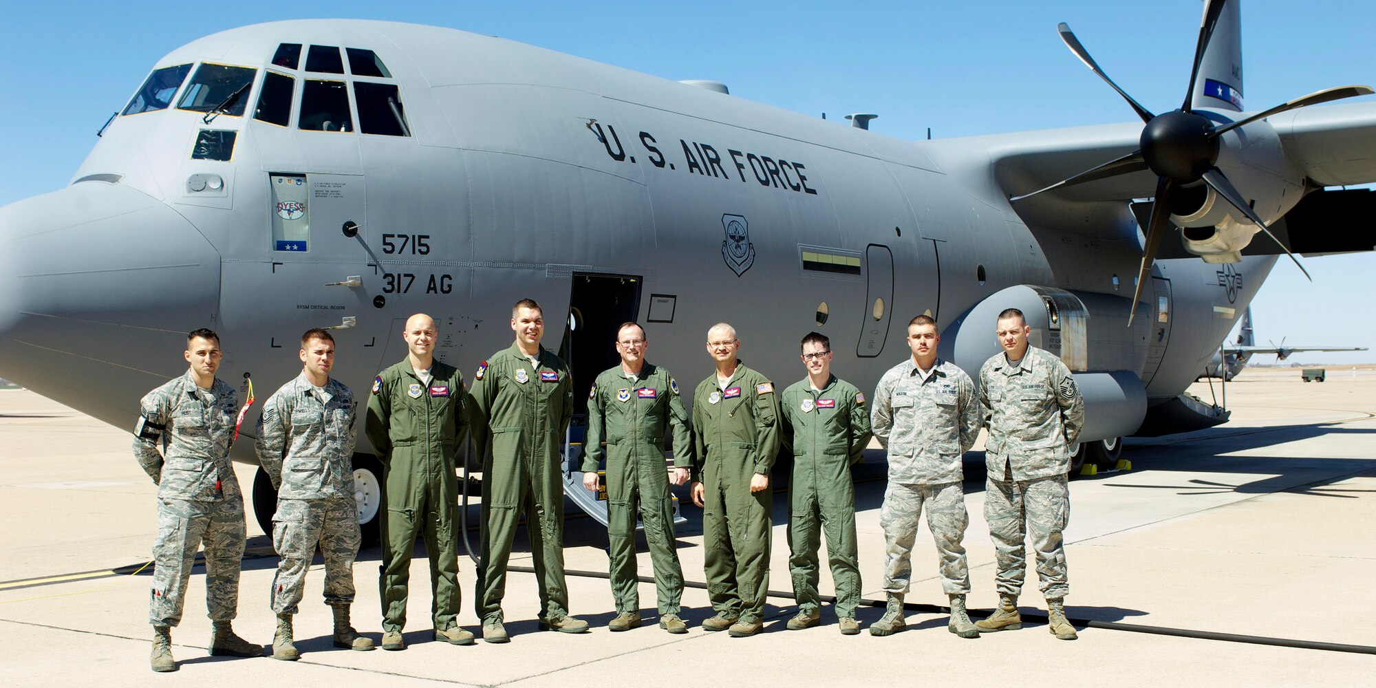 Members of the 317th Airlift Group pose for a group photo with Air Force Maj. Gen. Richard C. Johnston, assistant deputy under secretary of the Air Force, international affairs, after the delivery March 12, 2013, at Dyess Air Force Base, Texas. Dyess has received 26 of 28 J-Models and expects the next to be delivered in June. (U.S. Air Force photo by Airman 1st Class Kylsee Wisseman/ Released) 