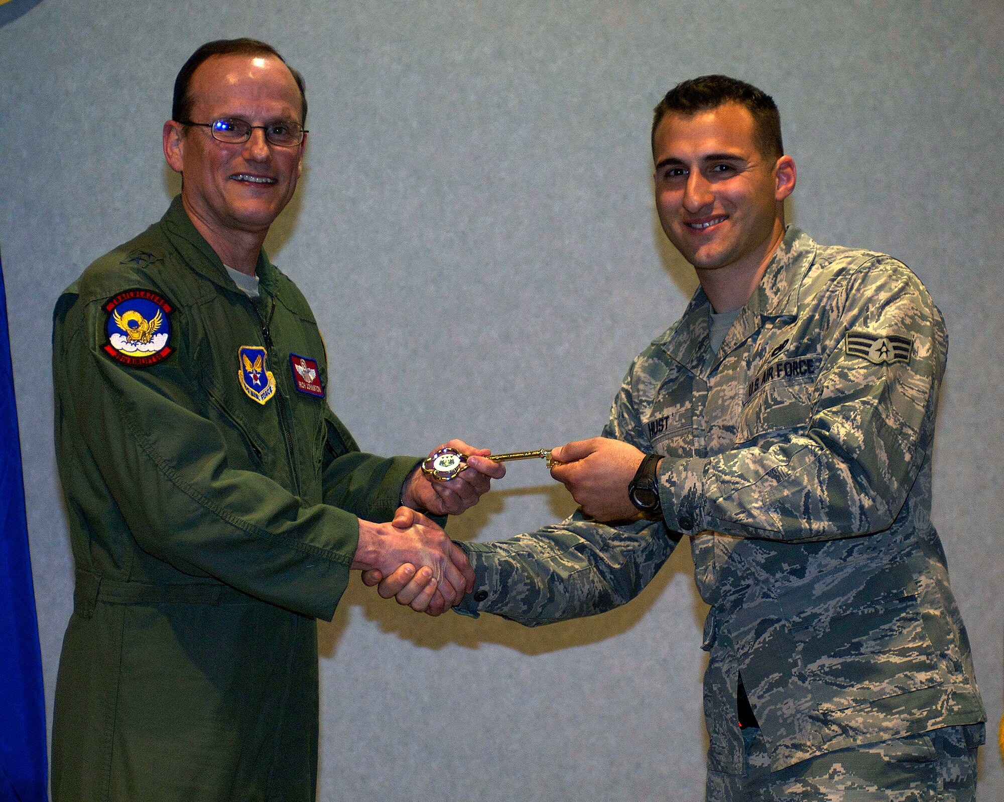 U.S. Air Force Maj. Gen. Richard C. Johnston, assistant deputy under secretary of the Air Force, international affairs, left, presents Senior Airman Jeremiah Hust, 317th Airlift Group, with the honorary key to the newest C-130J March 12, 2013, at Dyess Air Force Base, Texas. Dyess has received 26 of 28 J-Models and expects the next to be delivered in June. (U.S. Air Force photo by Airman 1st Class Kylsee Wisseman/ Released)