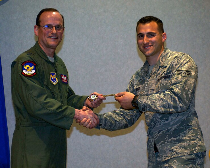U.S. Air Force Maj. Gen. Richard C. Johnston, assistant deputy under secretary of the Air Force, international affairs, left, presents Senior Airman Jeremiah Hust, 317th Airlift Group, with the honorary key to the newest C-130J March 12, 2013, at Dyess Air Force Base, Texas. Dyess has received 26 of 28 J-Models and expects the next to be delivered in June. (U.S. Air Force photo by Airman 1st Class Kylsee Wisseman/ Released)