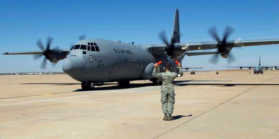 Senior Airman Jeremiah Hust, 317th Airlift Group, marshals in Dyess’ newest C-130J March 12, 2013, at Dyess Air Force Base, Texas. Dyess has received 26 of 28 J-Models and expects the next to be delivered in June. (U.S. Air Force photo by Airman 1st Class Kylsee Wisseman/ Released)